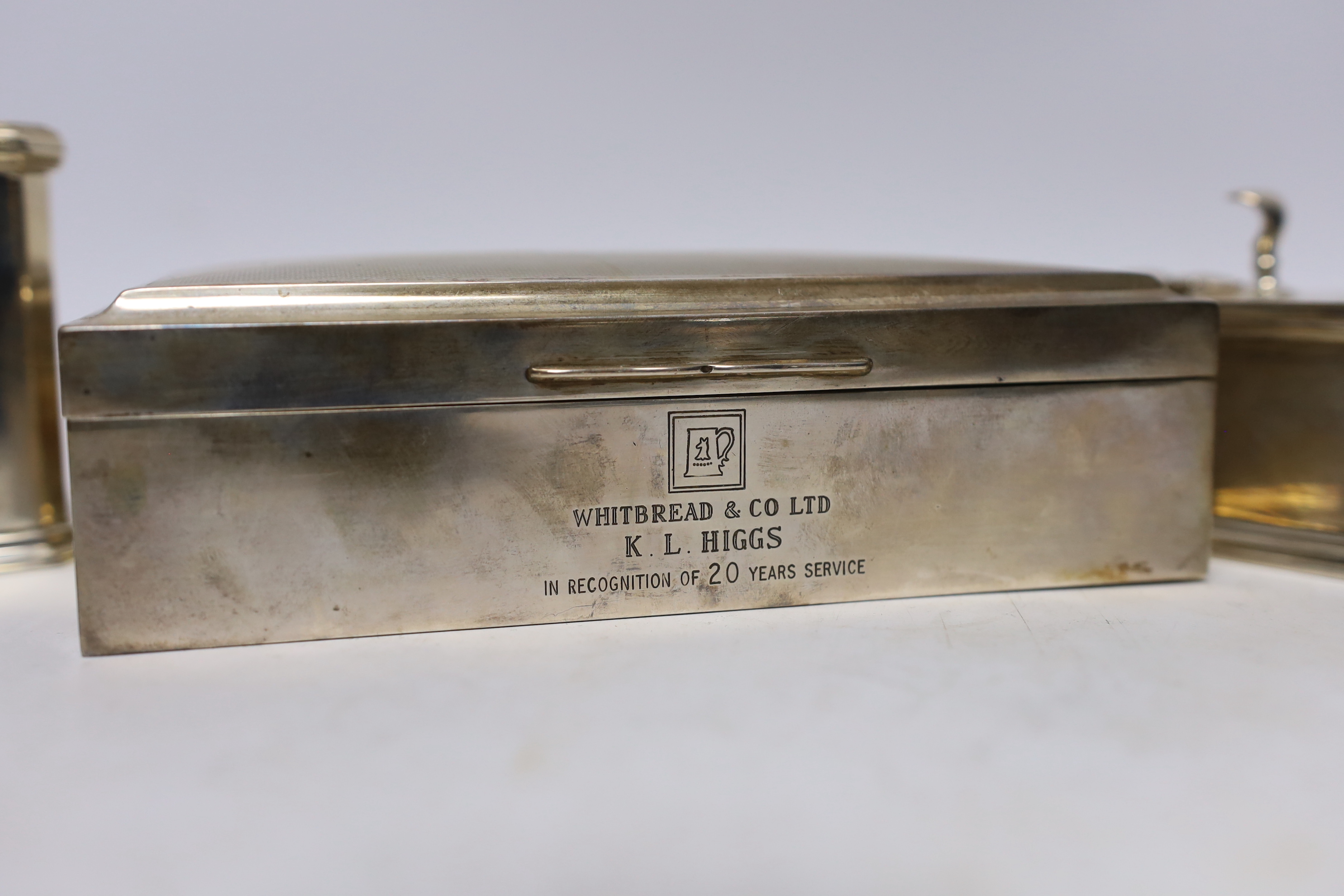A modern silver mounted rectangular cigarette box, 17.1cm and a George VI three piece silver condiment set 1936/7 & 1941.